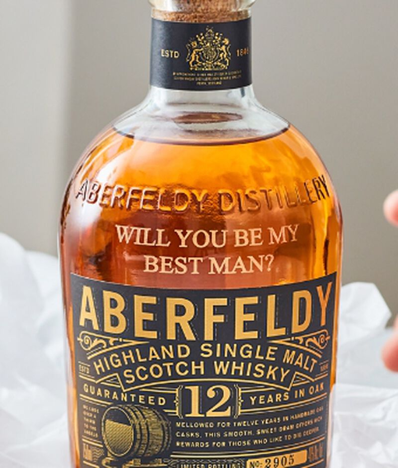 A bottle of Aberfeldy scotch custom engraved with "Will You Be My Best Man?"
