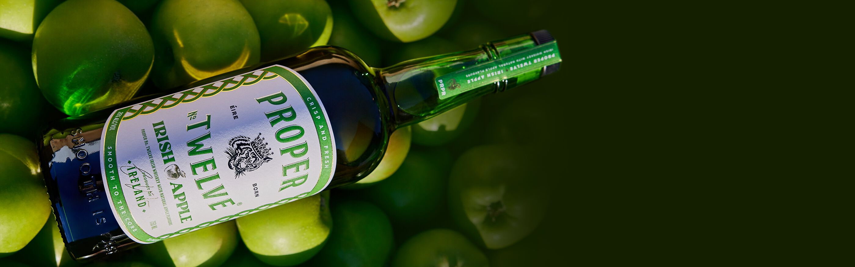 Bottle of Proper No. Twelve™️ Irish Apple with green apples