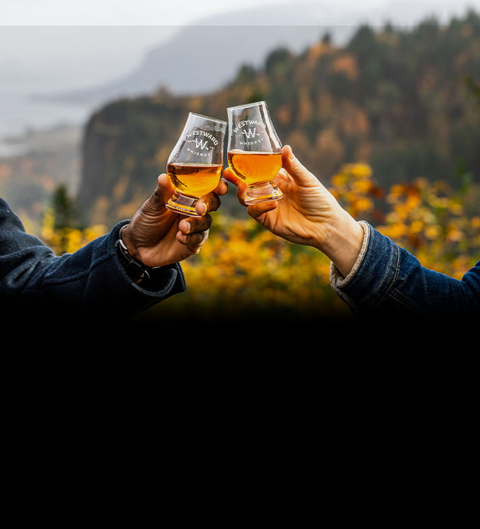 Two people toast a dram of Westward Whisky