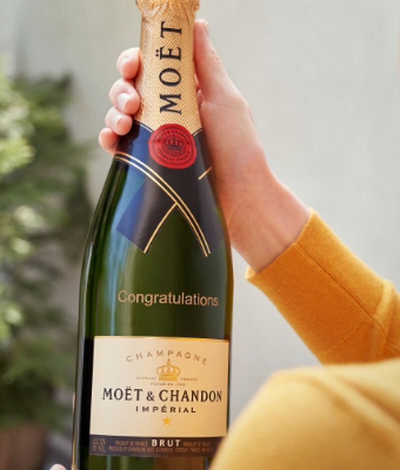  A bottle of Moet Champagne that has been engraved with a custom birthday message