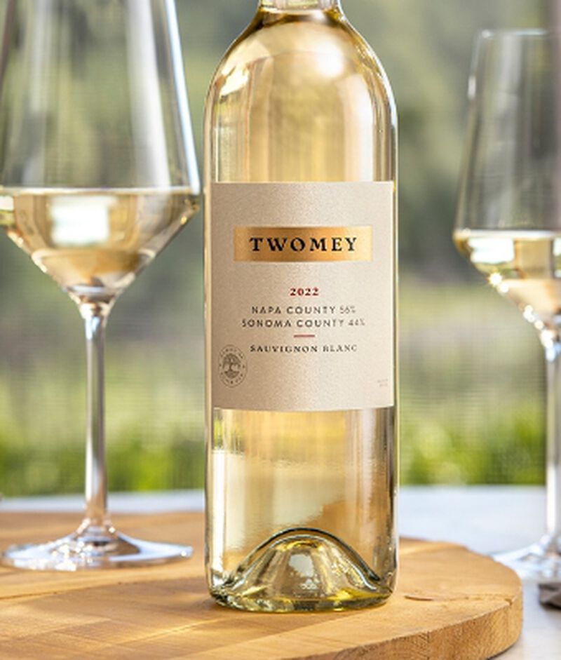 Bottle of Twomey Napa/Sonoma County Sauvignon Blanc with two wine glasses outside