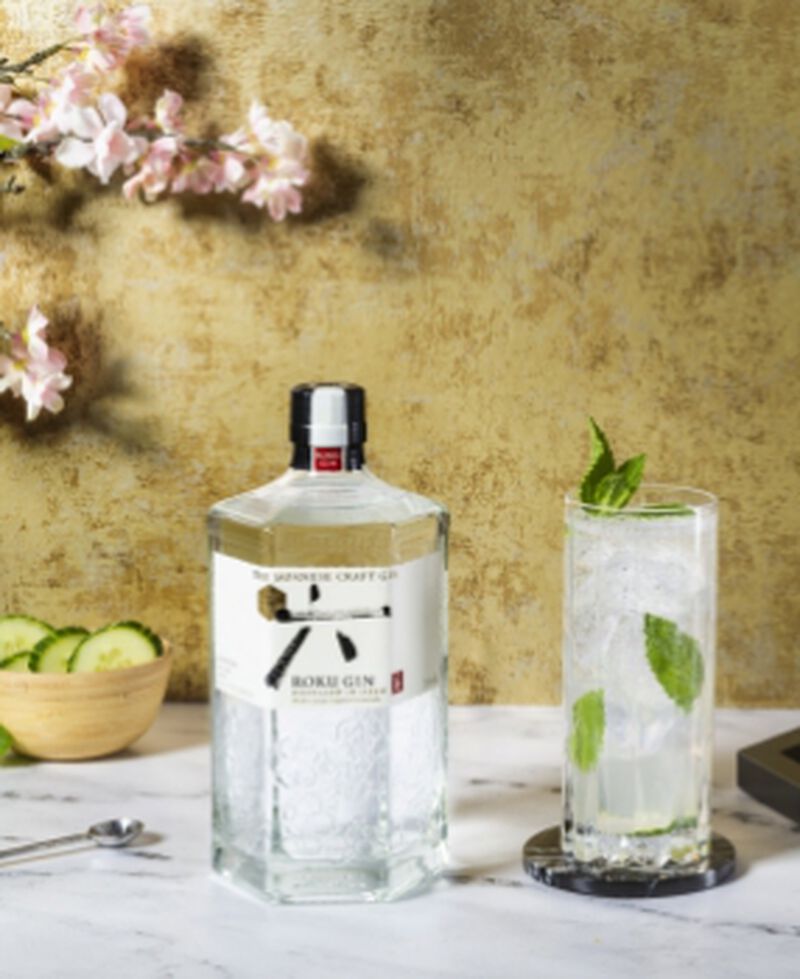 A bottle of Roku Gin with a cocktail