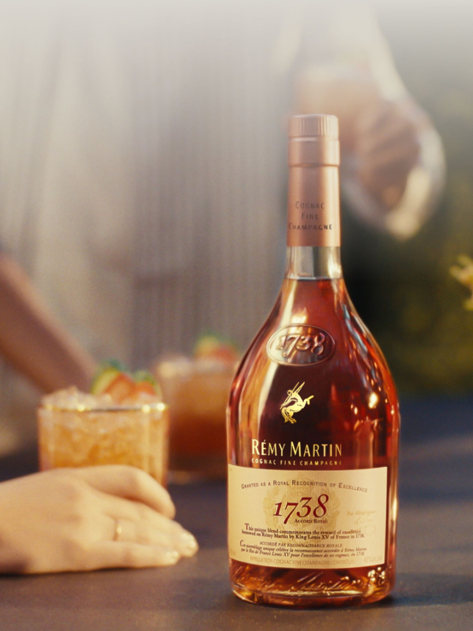 Bottle of Rémy Martin 1738 Accord Royal End Of Year Limited Edition with a cocktail