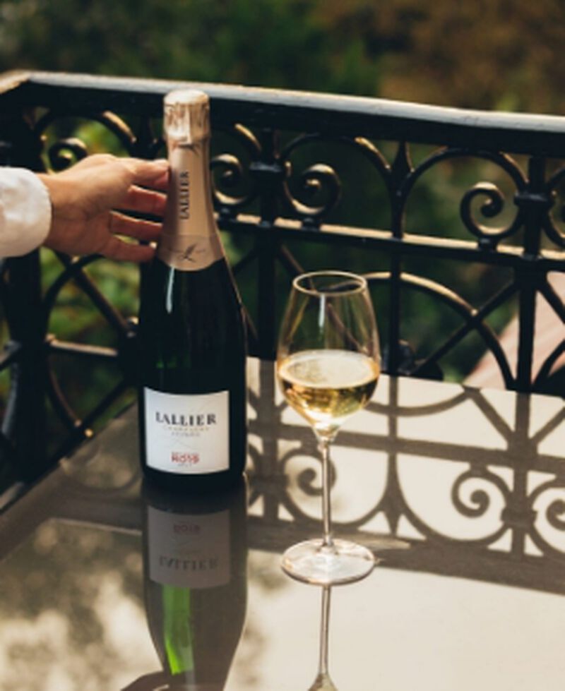 Bottle of Lallier Réflexion R.019 Brut Champagne outside with a glass