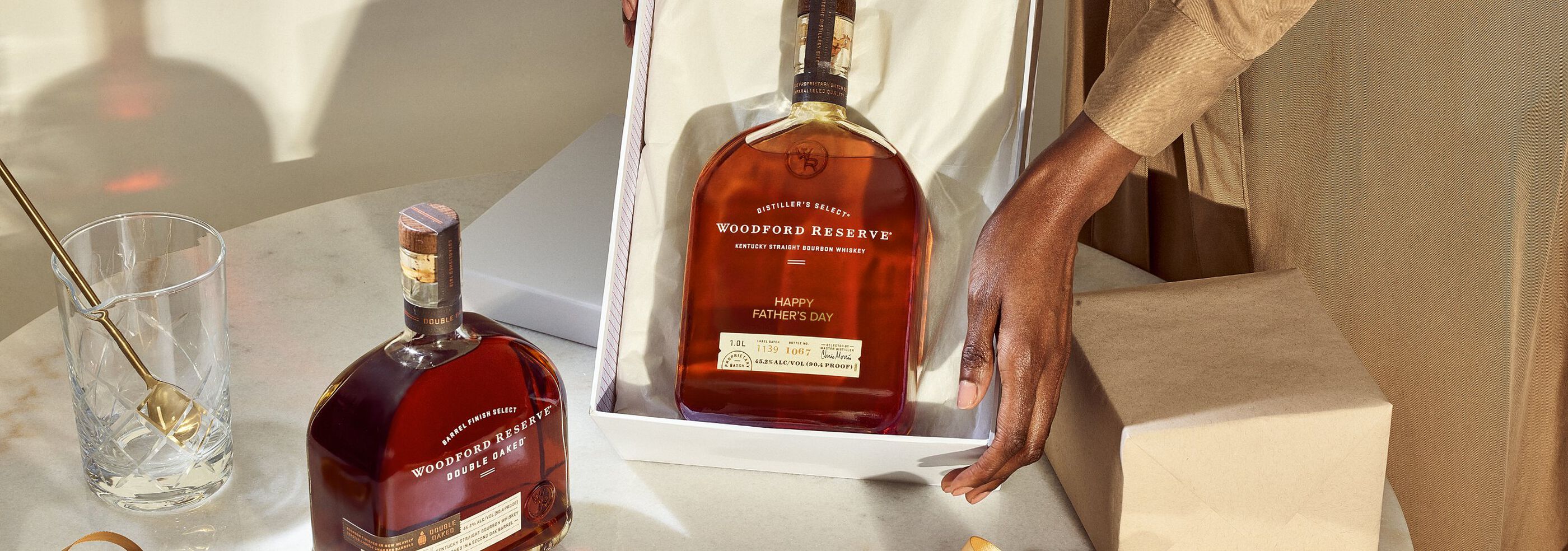 Person holding gift box with Woodford Reserve that is laser-engraved with the message "Happy Father's Day"
