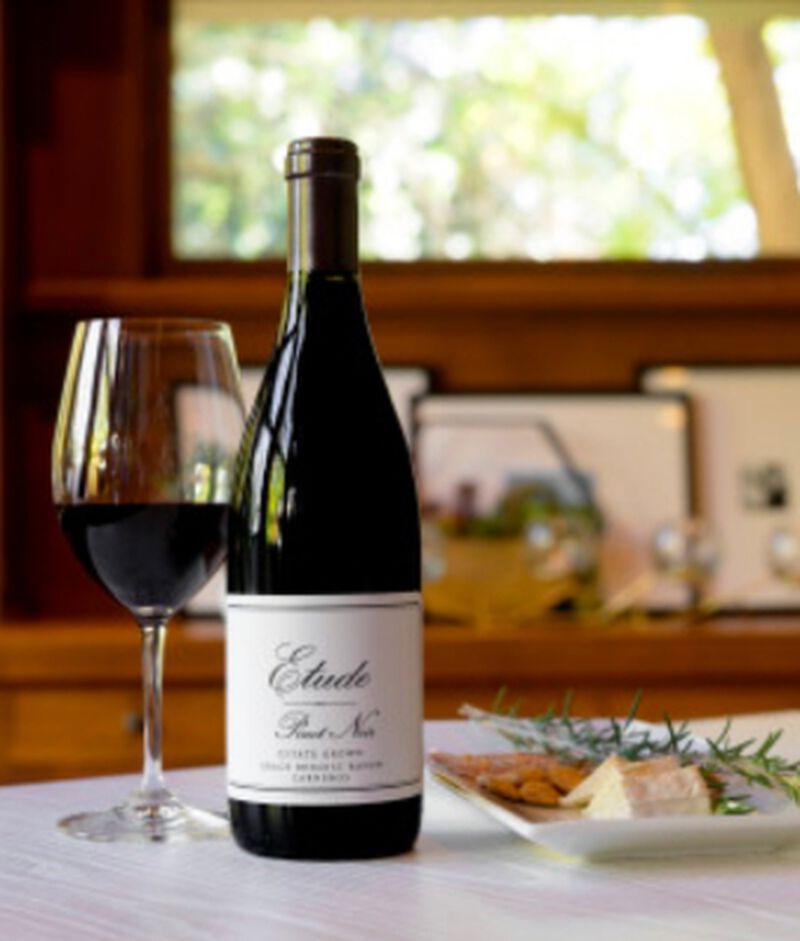 Bottle of Etude 'Grace Benoist Ranch' Carneros Pinot Noir with a glass and plate of food