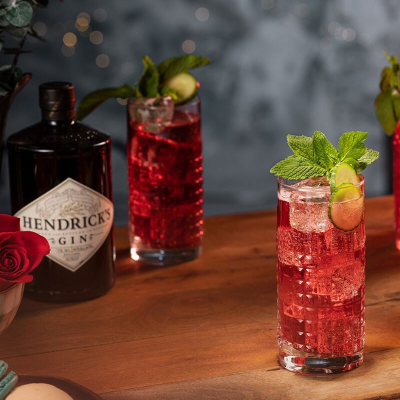 Hendrick's bottle with two Cranberry Fizz cocktails