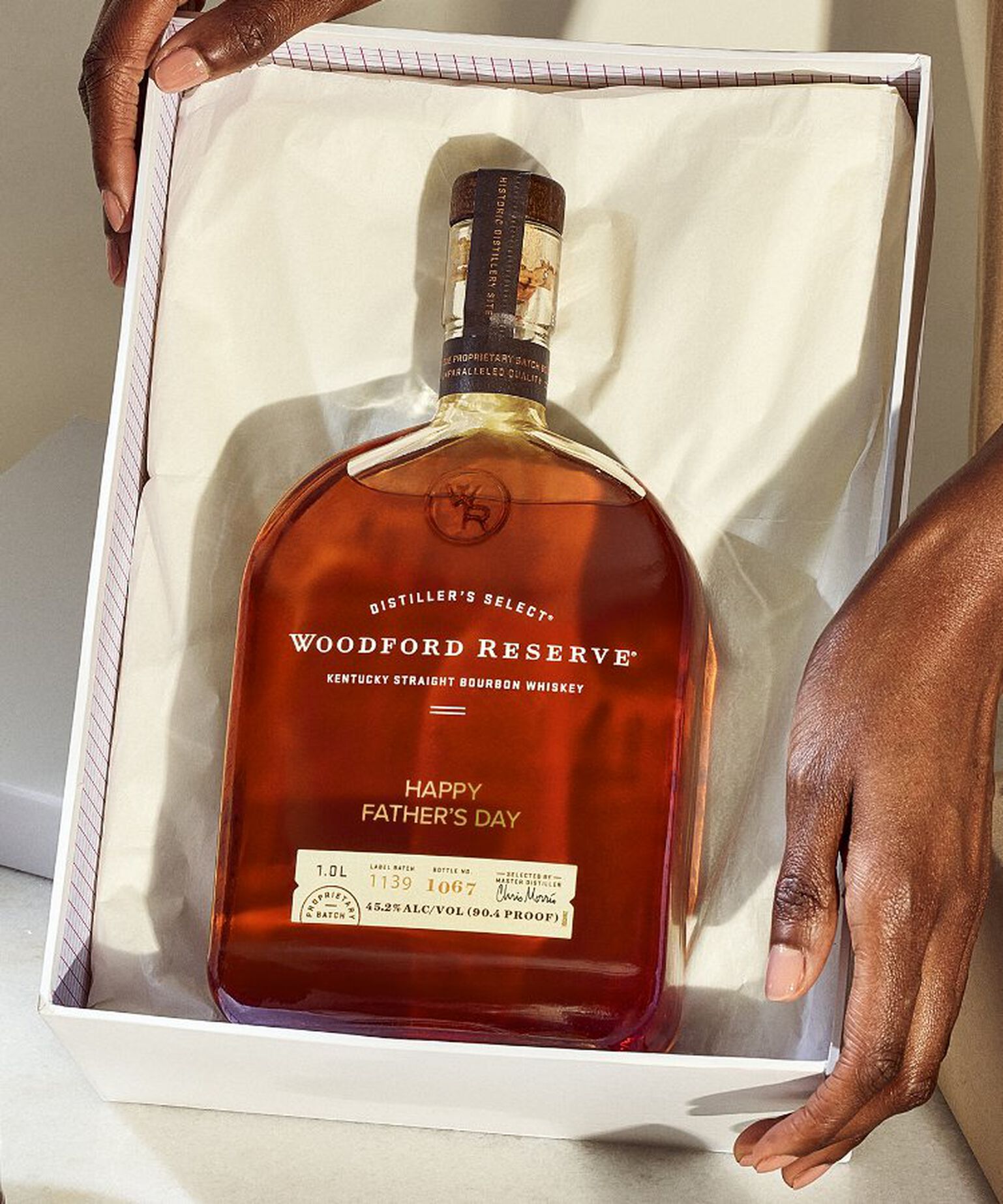 Person holding gift box with Woodford Reserve that is laser-engraved with the message "Happy Father's Day"