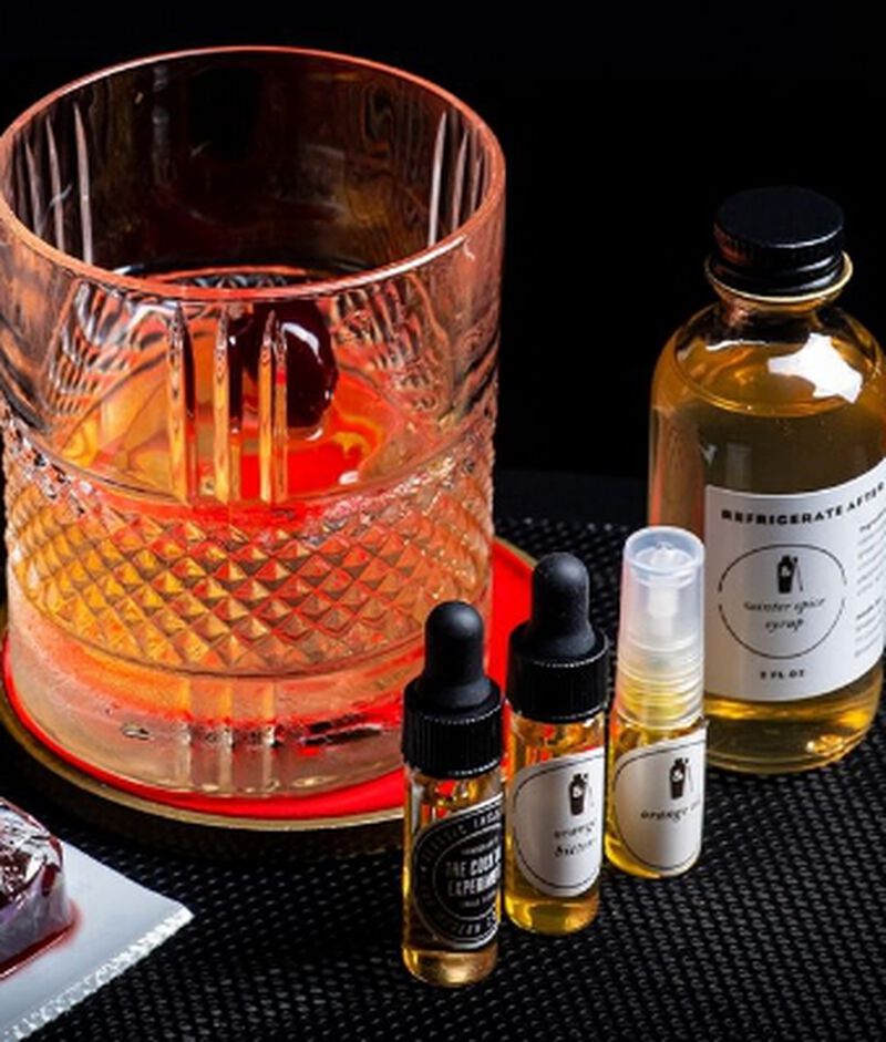 cocktail-kit with 4 small bottles and a cocktail
