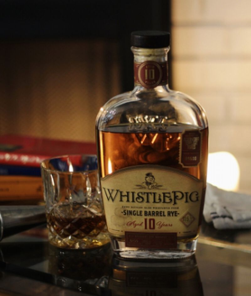 Bottle of WhistlePig 10YO Single Barrel Rye S1B51 with a cocktail