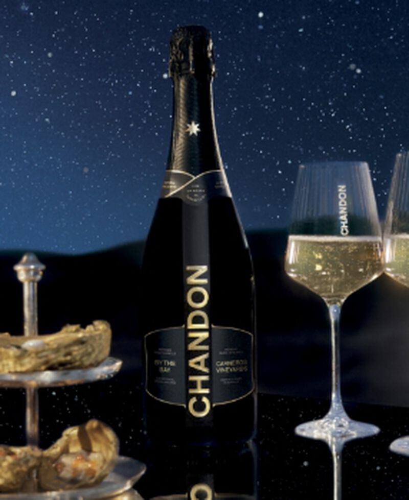 Bottle of Chandon By the Bay with champagne flutes