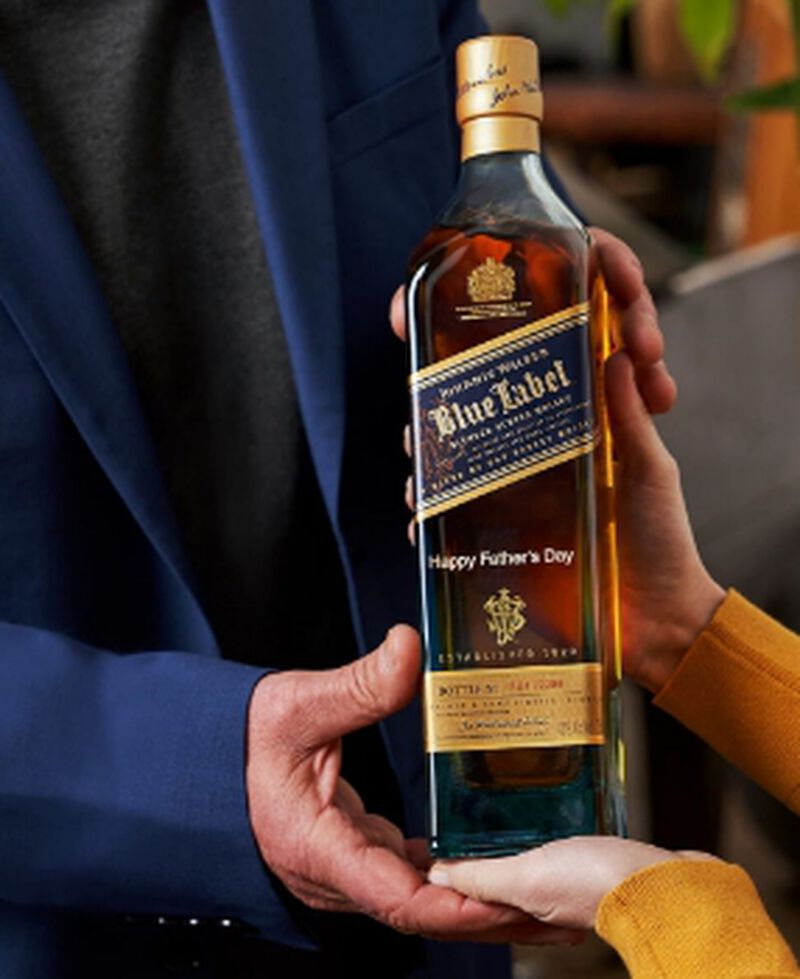 A bottle of Johnnie Walker Blue Label engraved with "Happy Father's Day"
