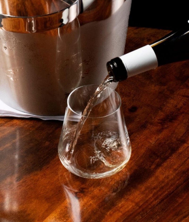 Wine being poured into a DrinkArt Stemless Universal Glass