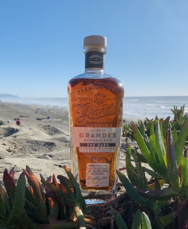 Bottle of Grander Rum 10 Year Old The Oaks Single Barrel S2B6 on a beach