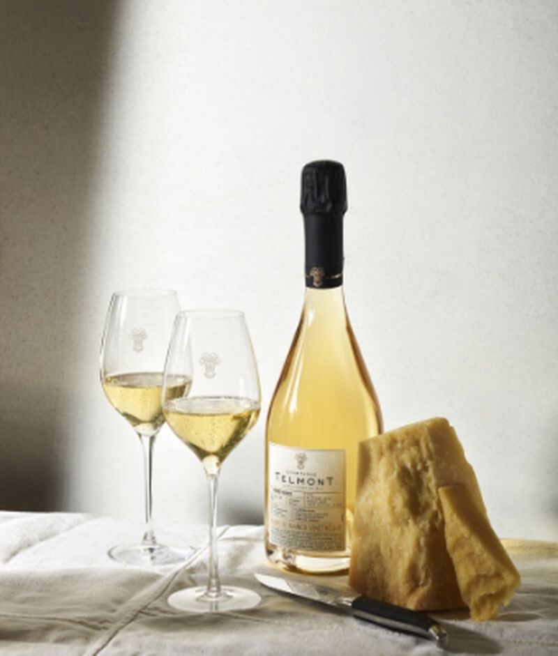 Bottle of Telmont Blanc De Blancs Vinothèque 2006 with two champagne flutes
