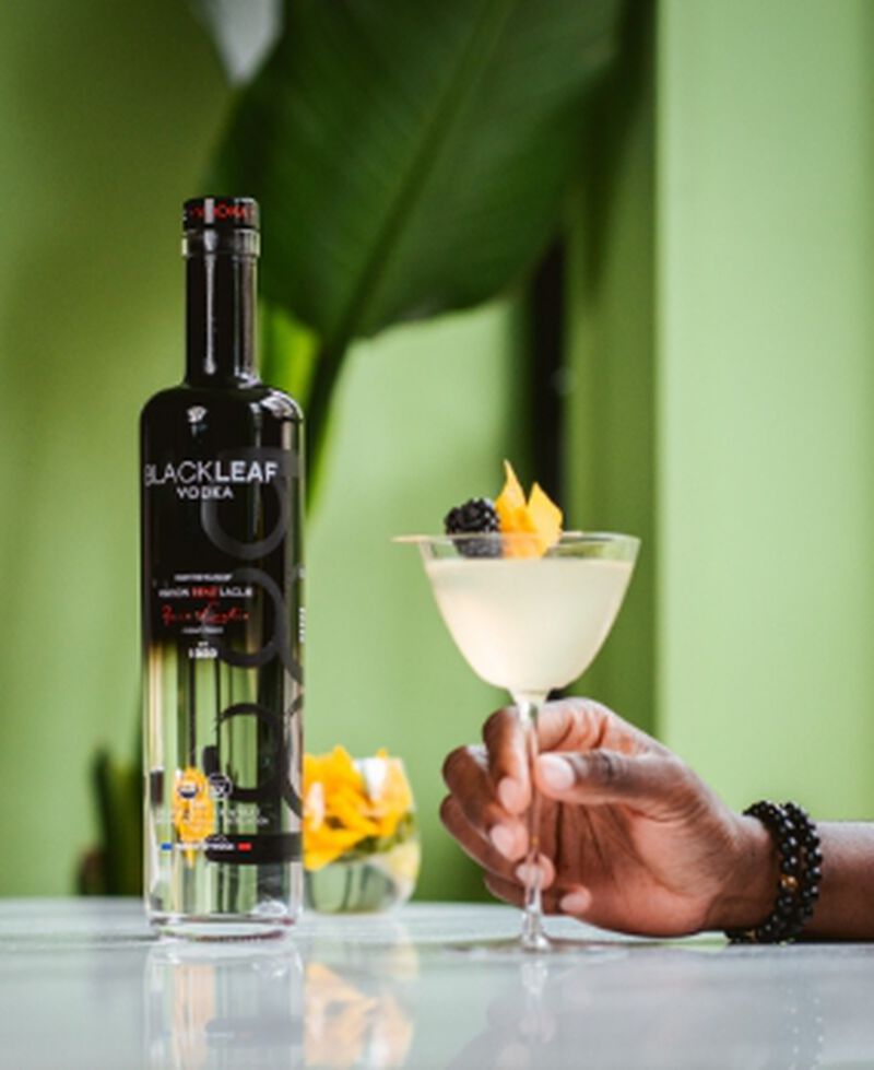 Bottle of Blackleaf Organic Vodka with a cocktail garnished with a yellow flower