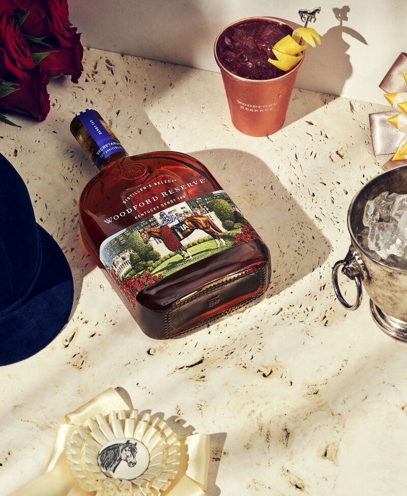 A bottle of Woodford Reserve® 2023 Kentucky Derby® 149 laying on a counter with cocktail supplies