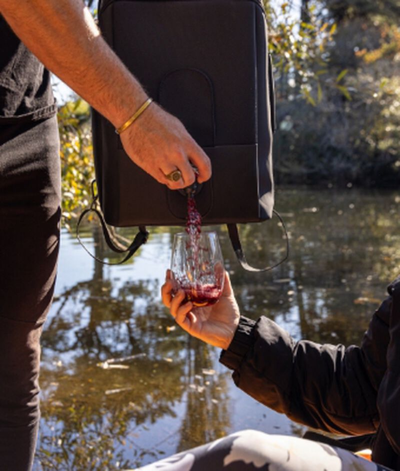 VinXplorer Wine & Beverage Backpack being poured into wine lass in the mountains