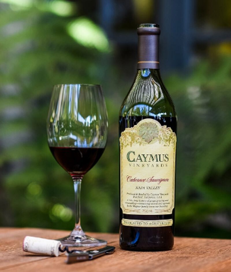 Bottle of Caymus Napa Valley Cabernet Sauvignon with a glass
