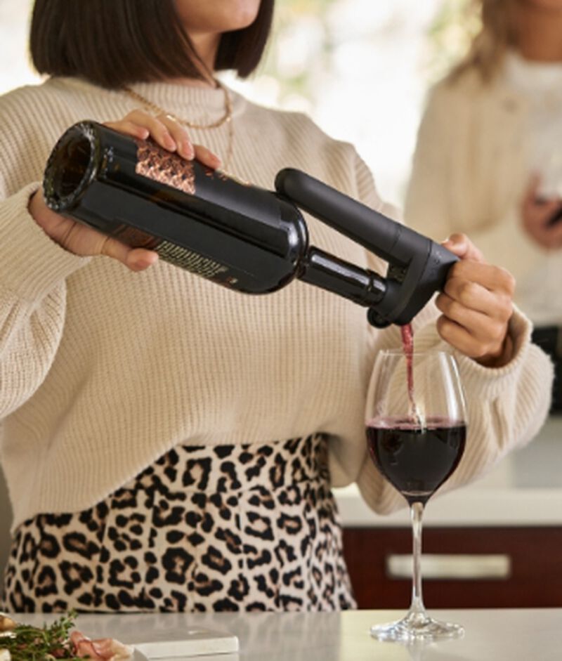 A Coravin Pivot™ Black being used to pour a glass of wine
