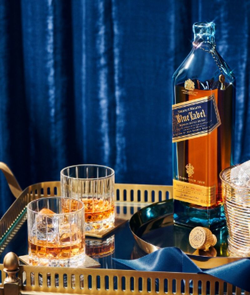 Bottle of Johnnie Walker Blue Label with cocktails - a brand from our Top 50 Gift Guide