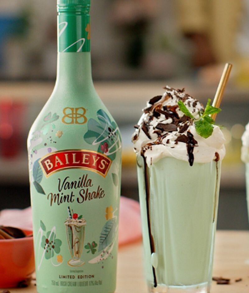 Bottle of Baileys Vanilla Mint Shake Irish Cream Liqueur with a green milkshake cocktail