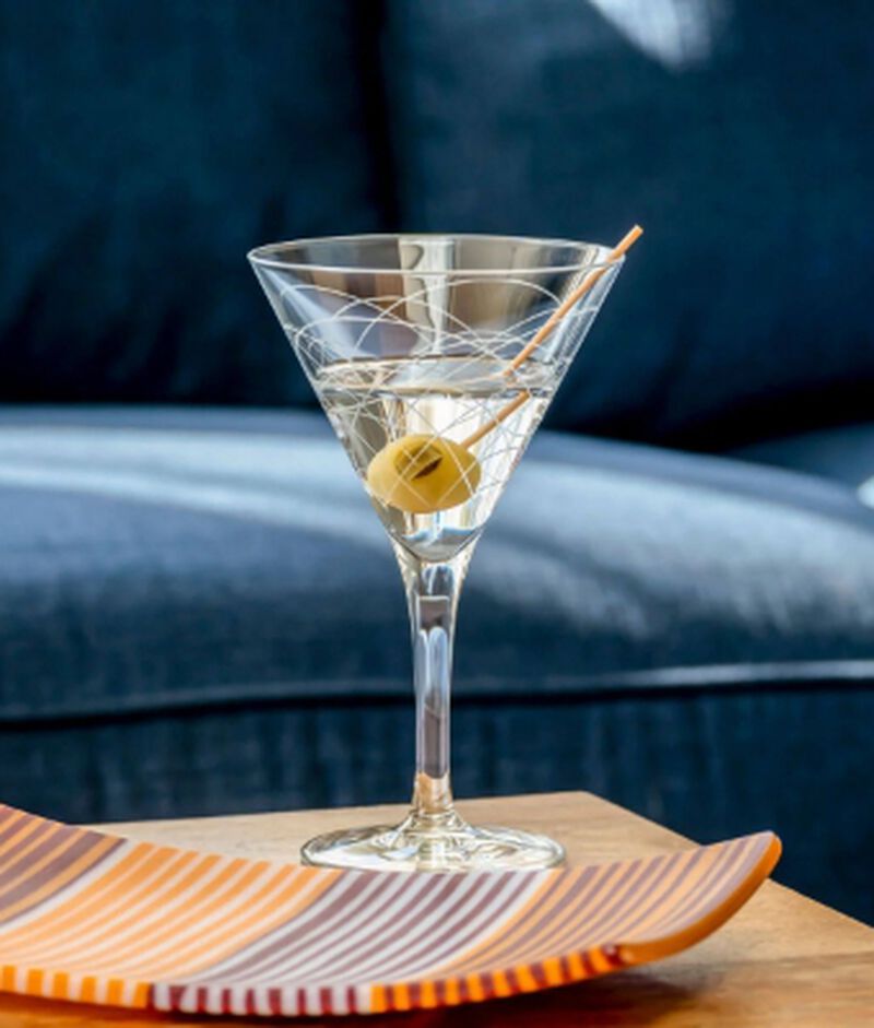 A beautiful Rolf Martini glass sitting on a table