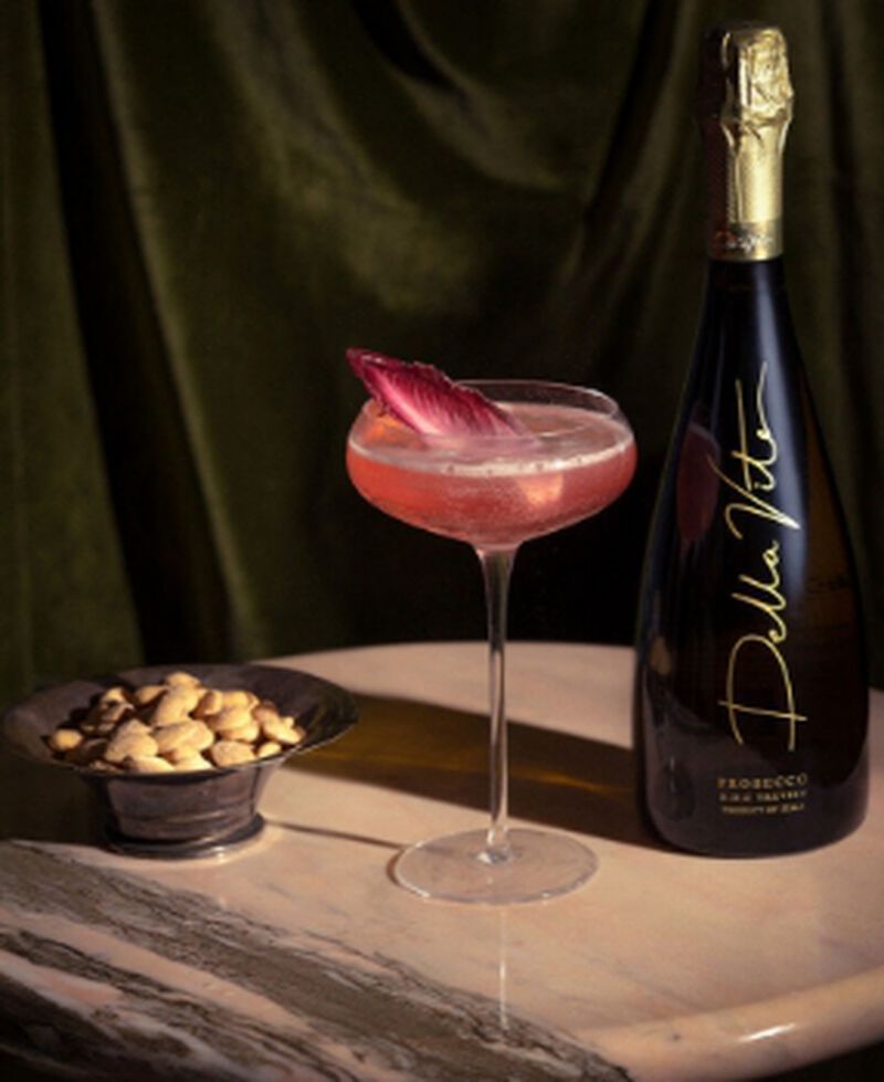 A bottle of Della Vite with a cocktail