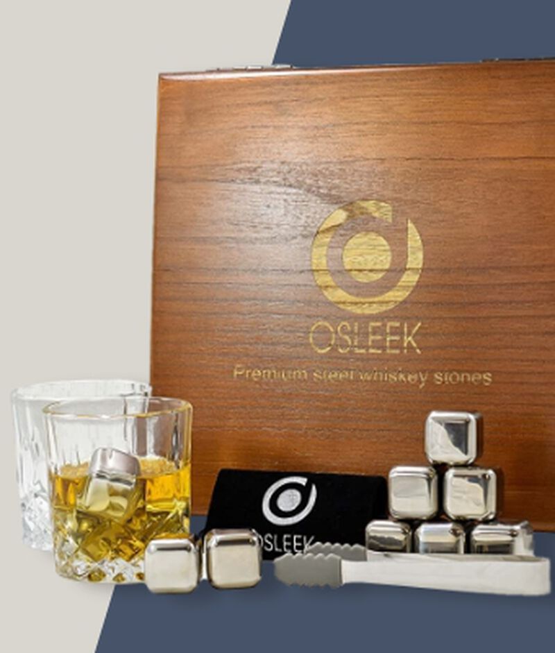 Osleek Premium Steel Whiskey Stone Set gift box on a tray with a rocks glass