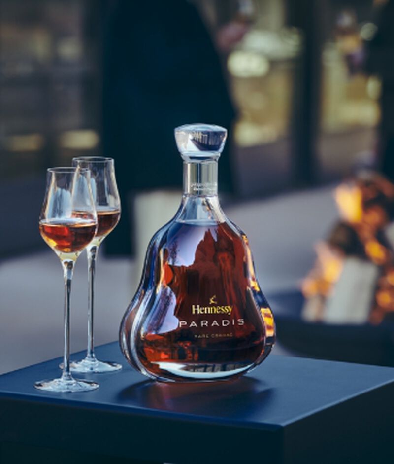 A bottle of Hennessy Paradis with two flute glasses