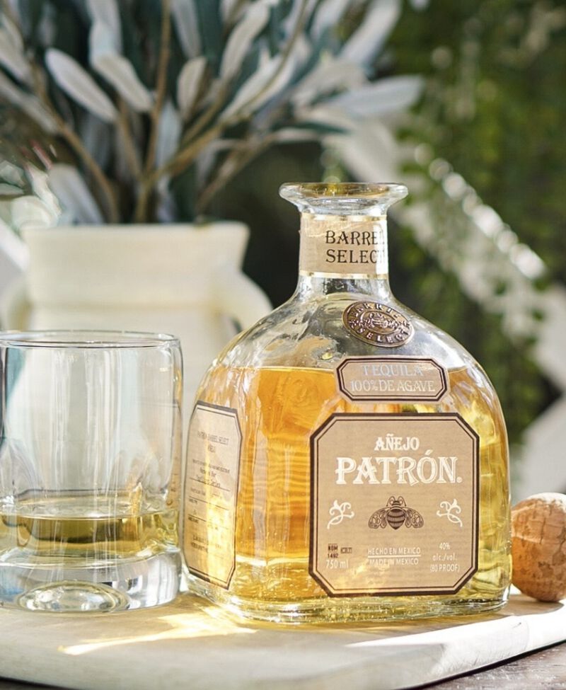 Bottle of PATRÓN® Barrel Select Anejo S1B47 with a rocks glass