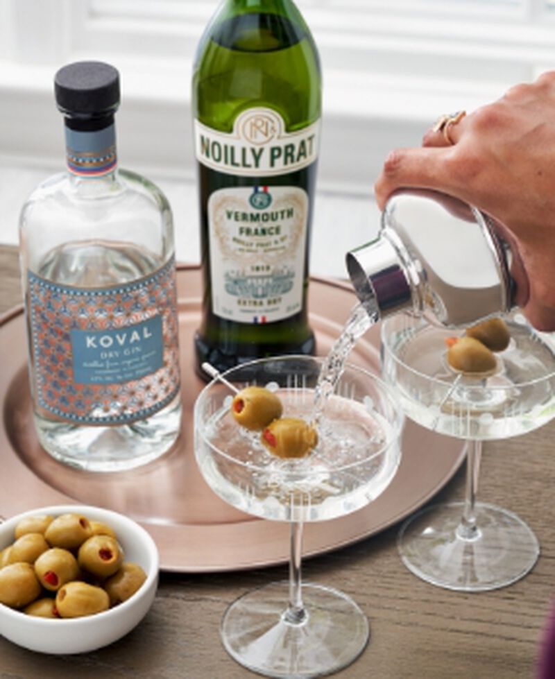 Cocktails being made in coupe glasses with olives