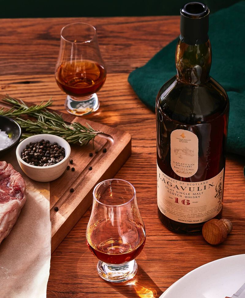 Bottle of Scotch with glasses and a steak dinner - perfect for Father's day!