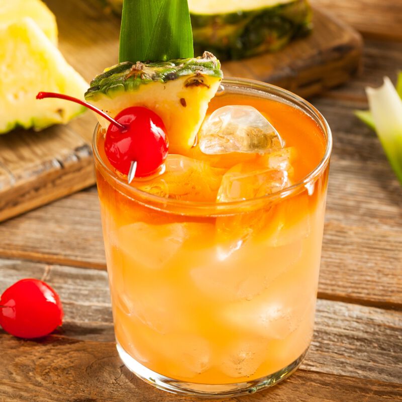 A beautiful Rum cocktail with cherry and pineapple garnish