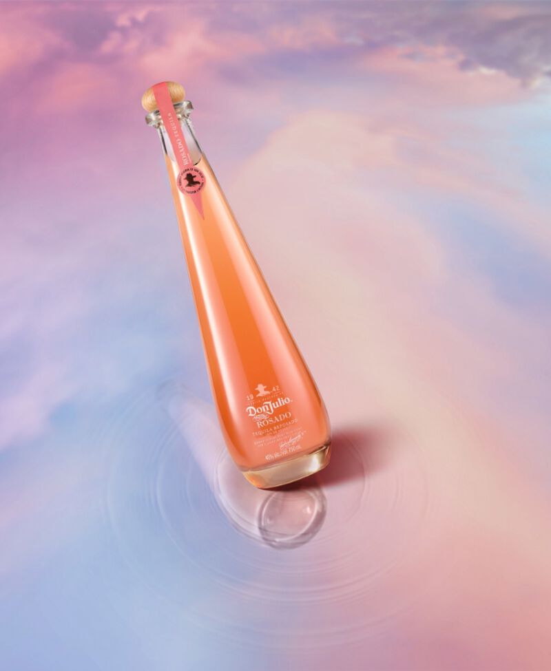 Bottle of Don Julio Rosado Tequila Reposado with pastel sky background