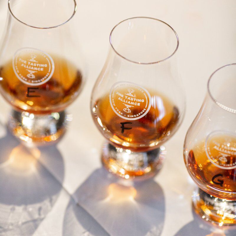 Tasting Alliance Glencairn glasses containing whiskey in a row