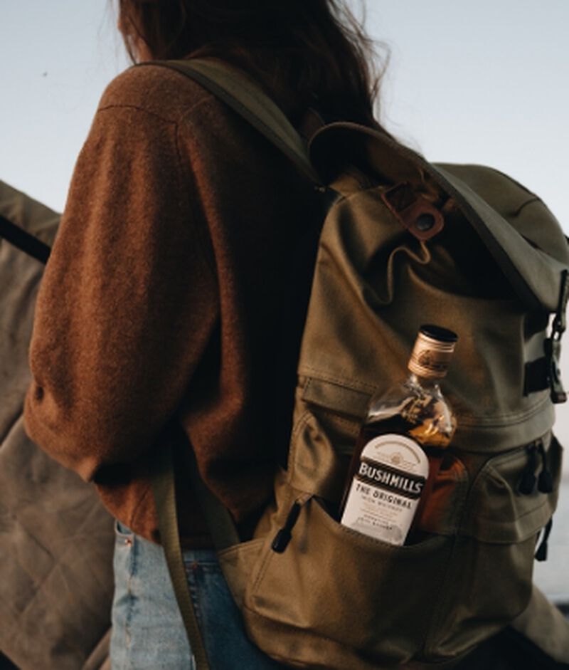 Bottle of Bushmills® Original in a woman's backpack