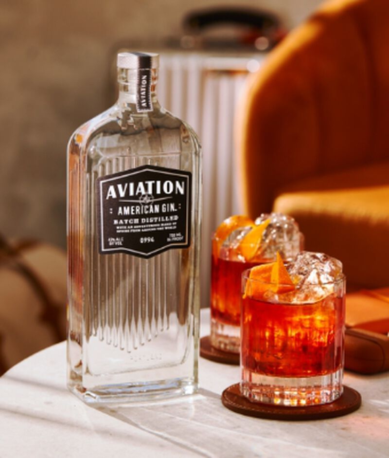 Bottle of Aviation American Gin with cocktails