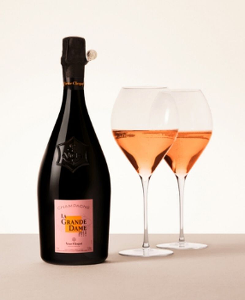 A bottle of Veuve Clicquot La Grande Dame Rosé with two filled champagne flutes