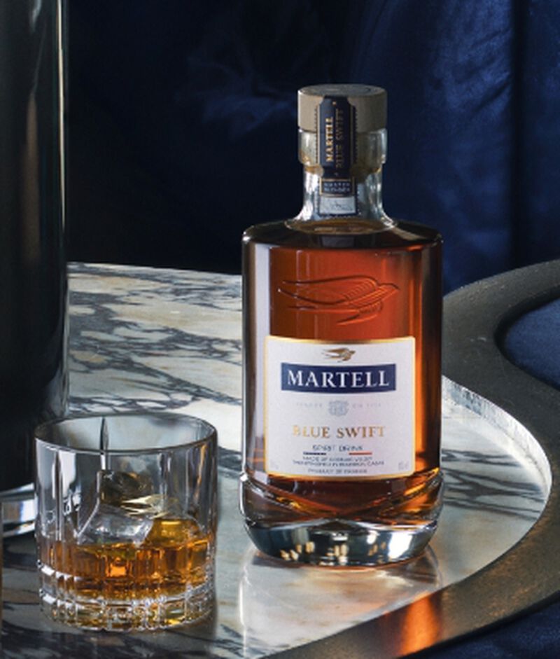 Bottle of Martell with rocks glass