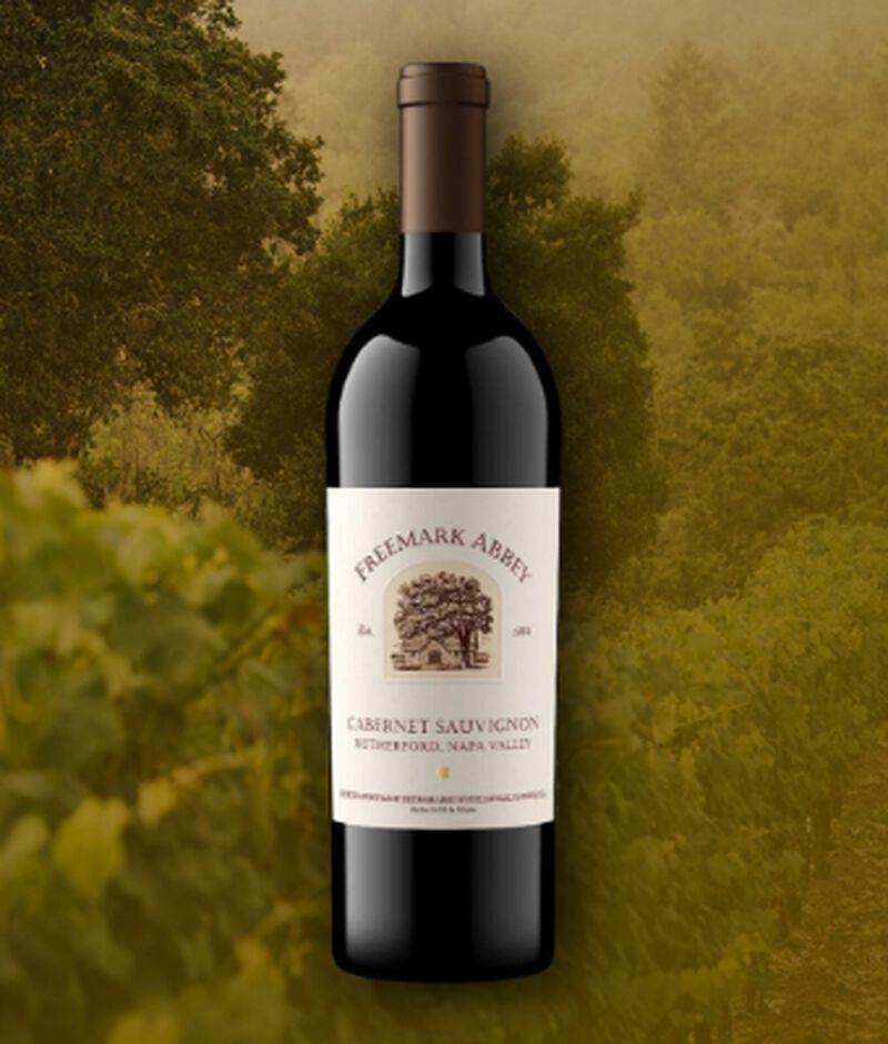 Bottle of Freemark Abbey Rutherford Cabernet Sauvignon with vineyard backdrop